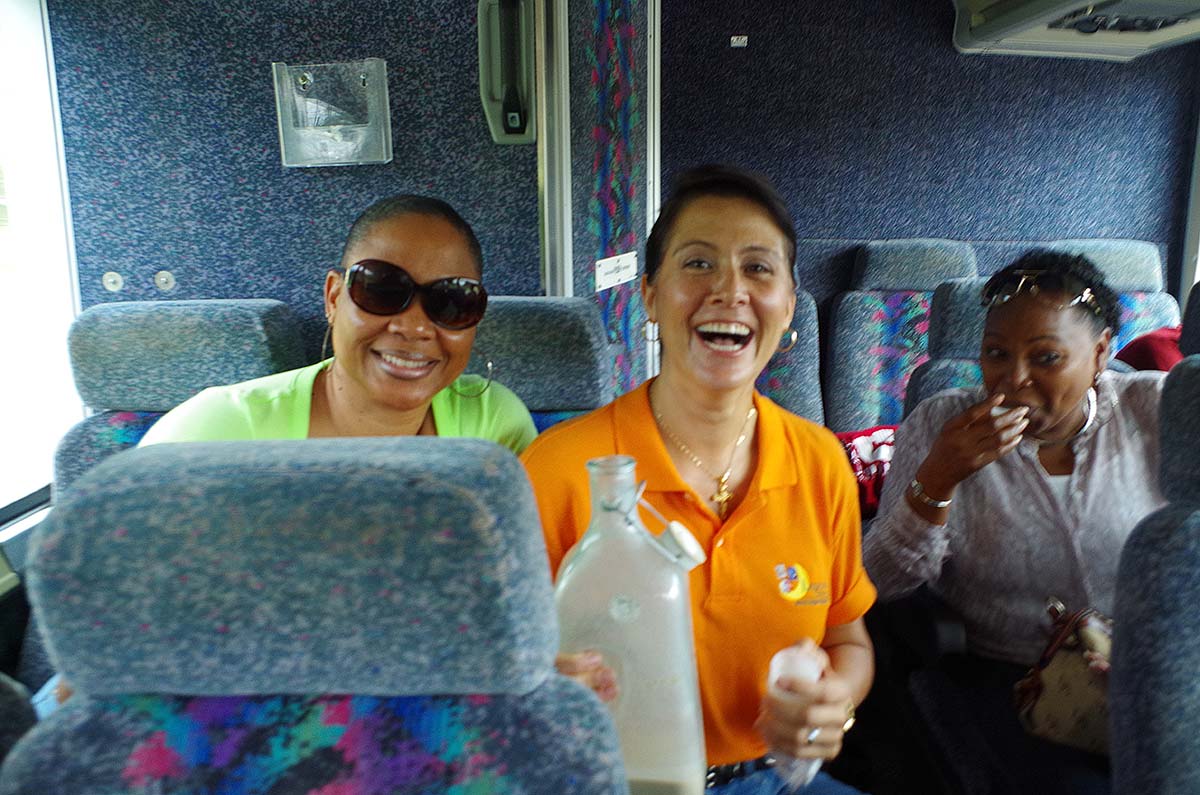 Tour guide sharing information with travelers inside a tour bus in Puerto Rico