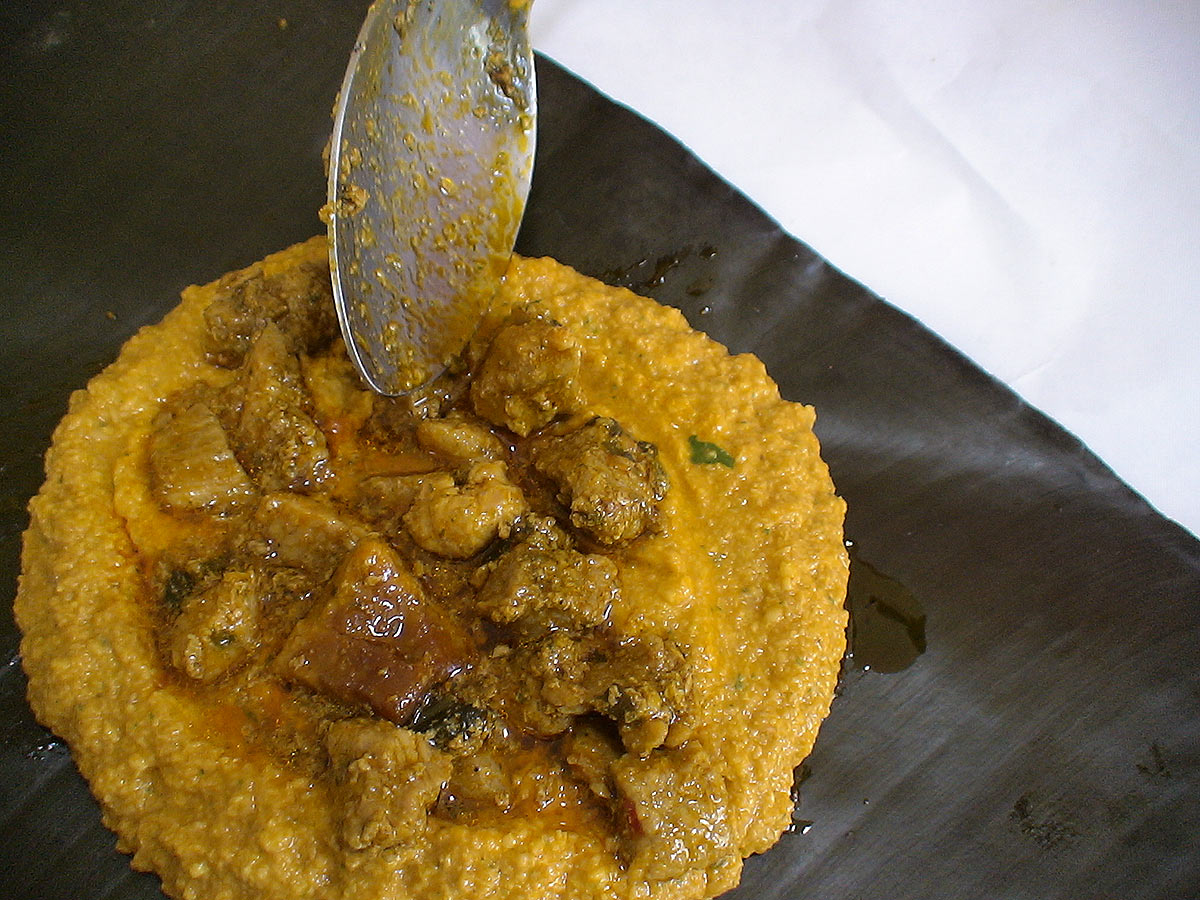 Pasteles dough with pork stew on a banana leaf